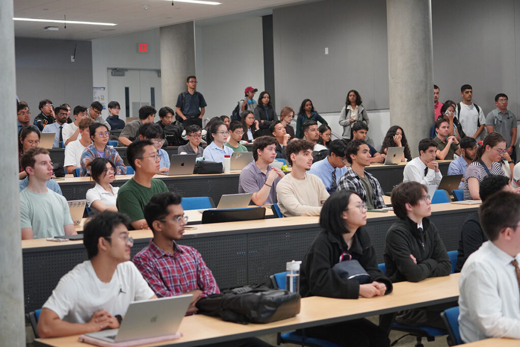 Students in an auditorium listening to lecture